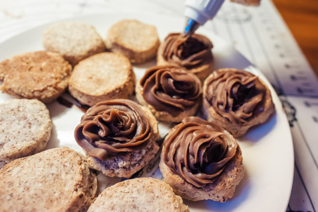 piping chocolate cream on sarah bernhardt cookies