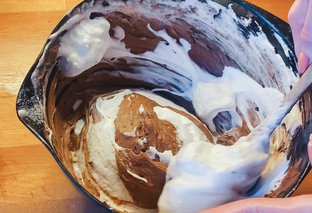folding egg whites into chocolate cake batter