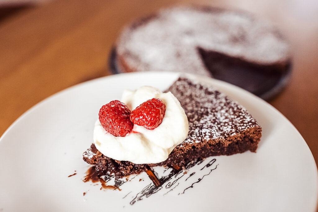 kladdkaka with whipped cream and berries