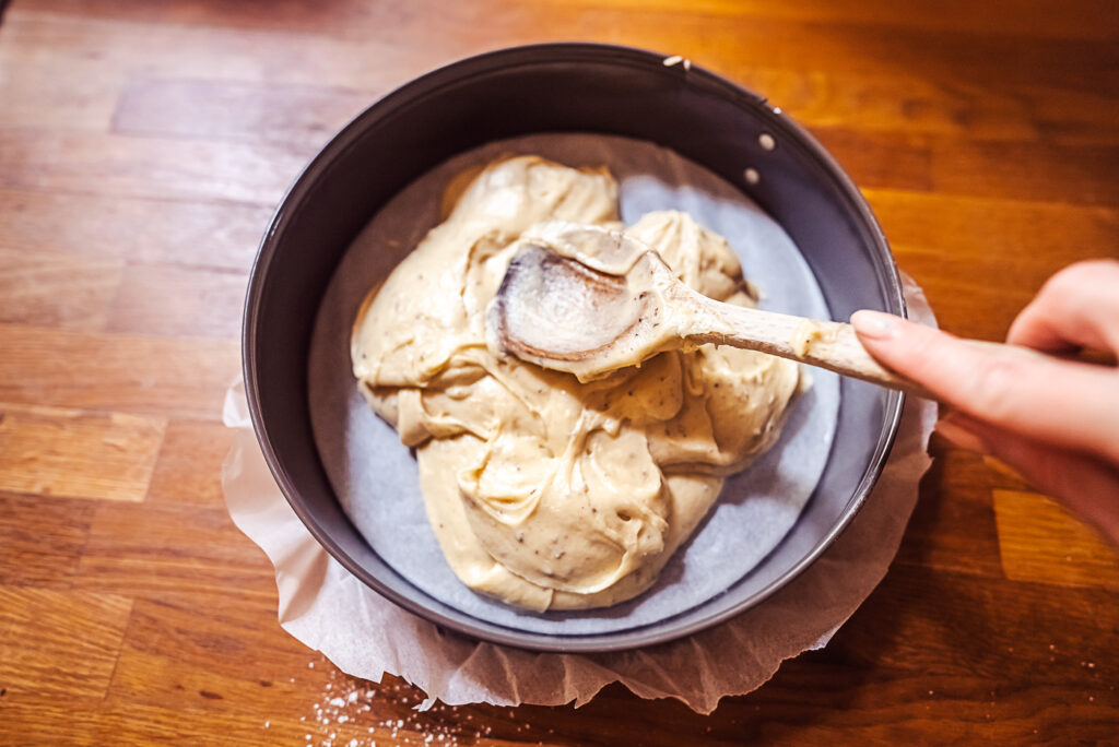 spreading cardamom cake batter on cake form