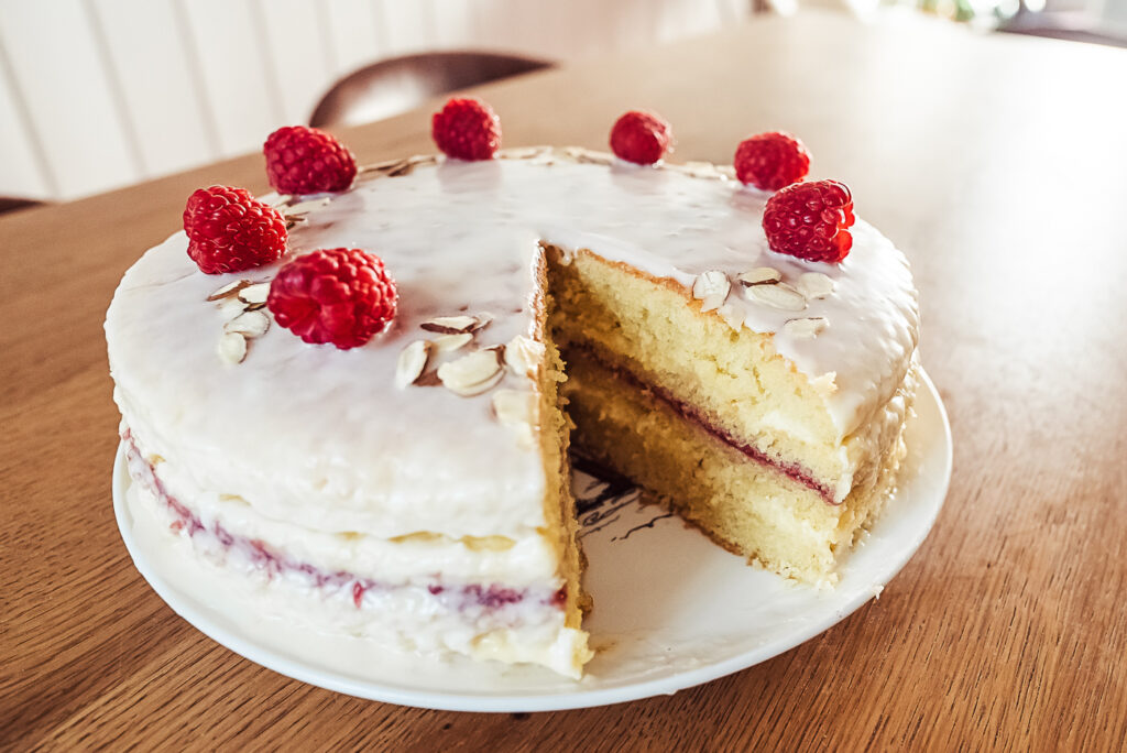 lagkage with raspberry jam, vanilla cream, and almond glaze