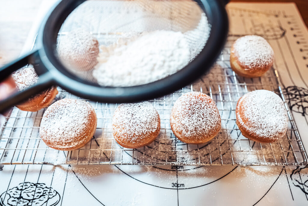 sprinkling doughnuts with sugar