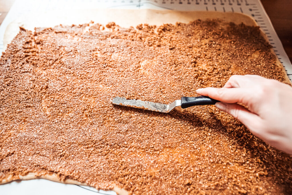 spreading almond cinnamon filling on kringle dough