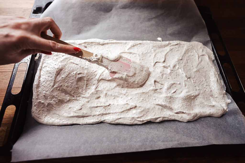 spreading fragilite cake batter on baking sheet