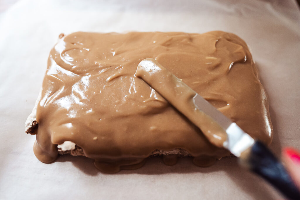 spreading coffee cream on fragilité cake