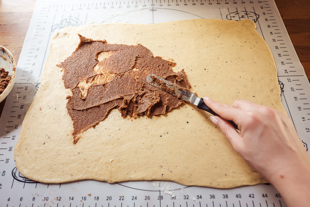 spreading kringle filling across dough