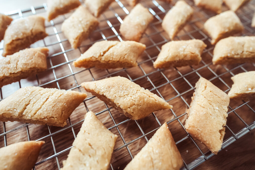 swedish butter cookies (kolasnittar) freshly cut and cooling on a wire rack