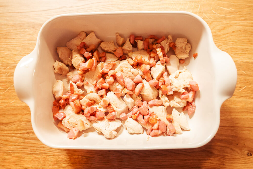 casserole dish with chicken and bacon on the bottom