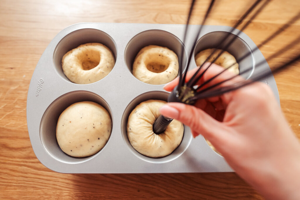 using the back of a whisk to make a well in skolebrød dough