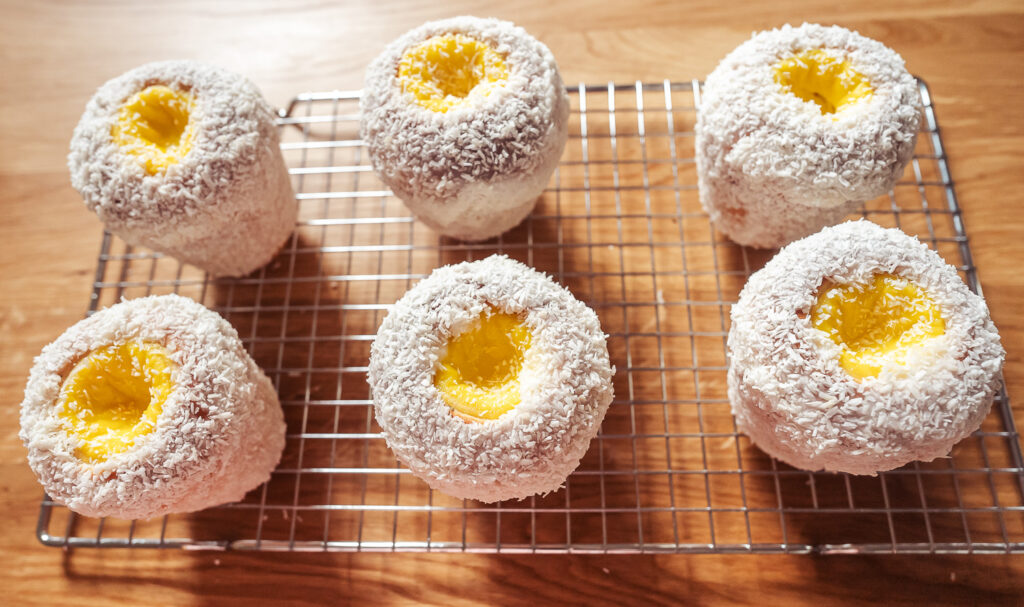 six school bread buns on a wire rack