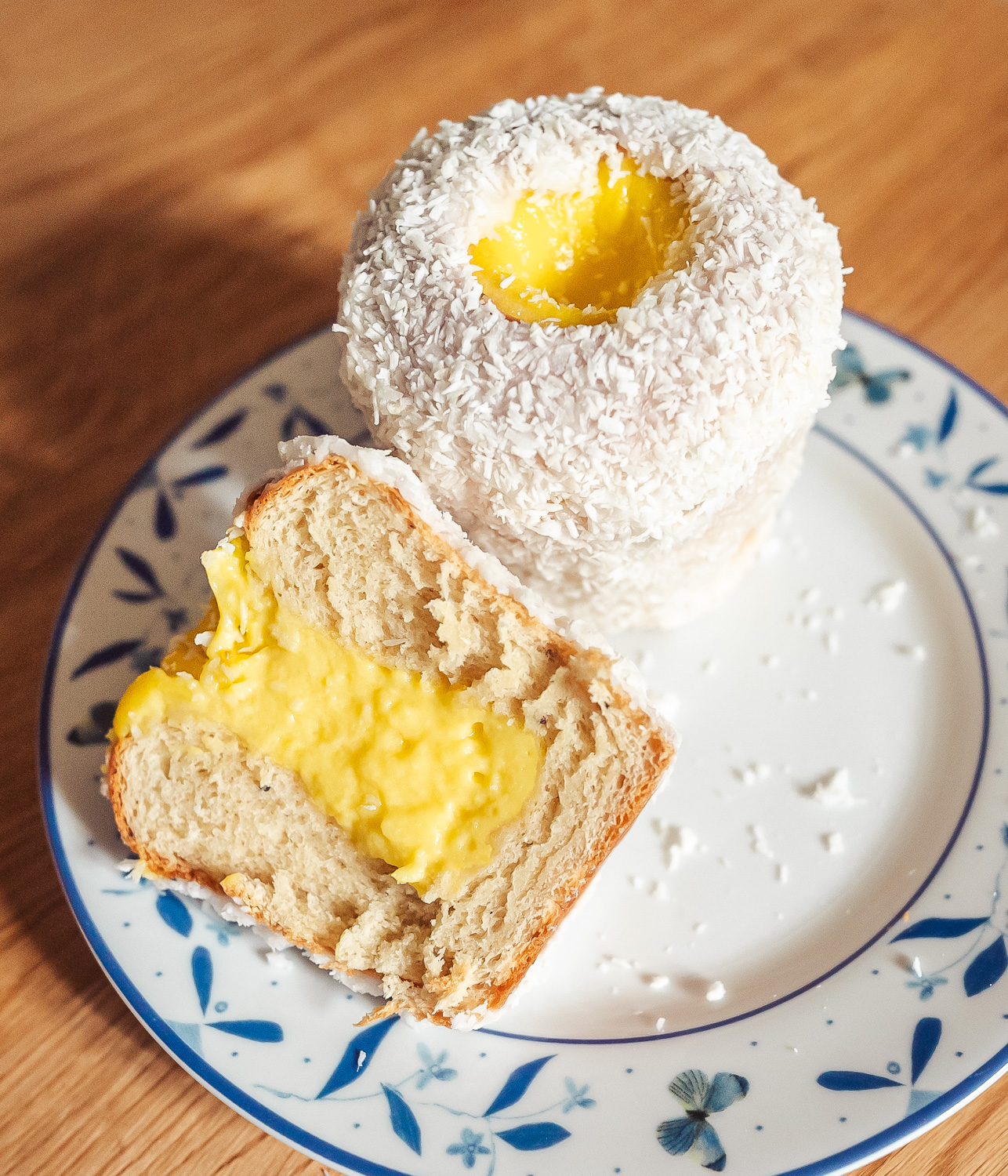 tall skoleboller school bread on a plate, one whole bun and one cut in half