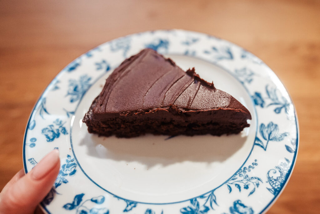 slice of kladdkaka Swedish chocolate cake with dark chocolate and coffee ganache on a blue and white plate