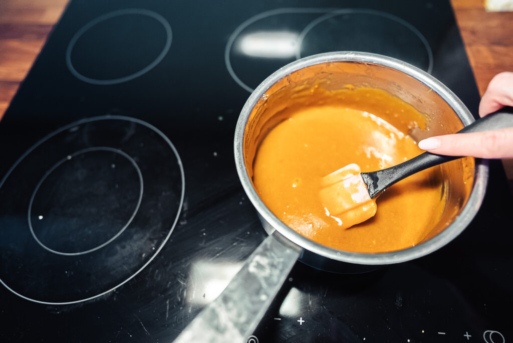 melting Norwegian brunost (brown cheese) in a saucepan with butter and sugar