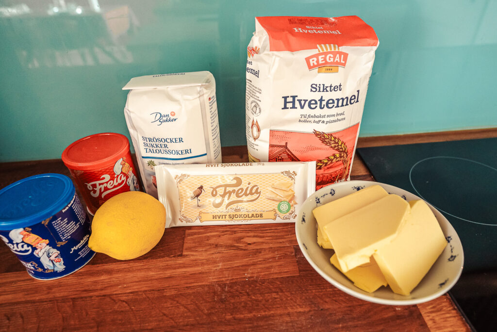 ingredients for making Swedish sliced lemon cookies set out on a wooden counter