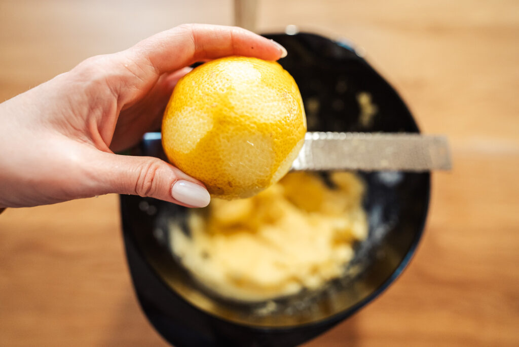 zesting a lemon to make Swedish citronsnittar