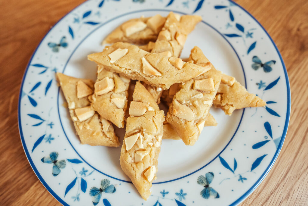 lemon and white chocolate slice cookies on a plate with blue butterflies
