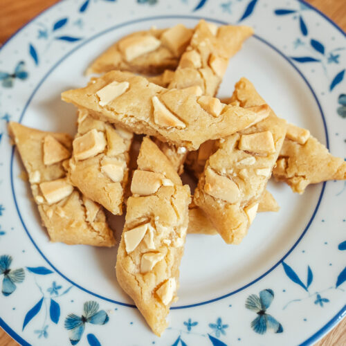 lemon and white chocolate slice cookies on a plate with blue butterflies