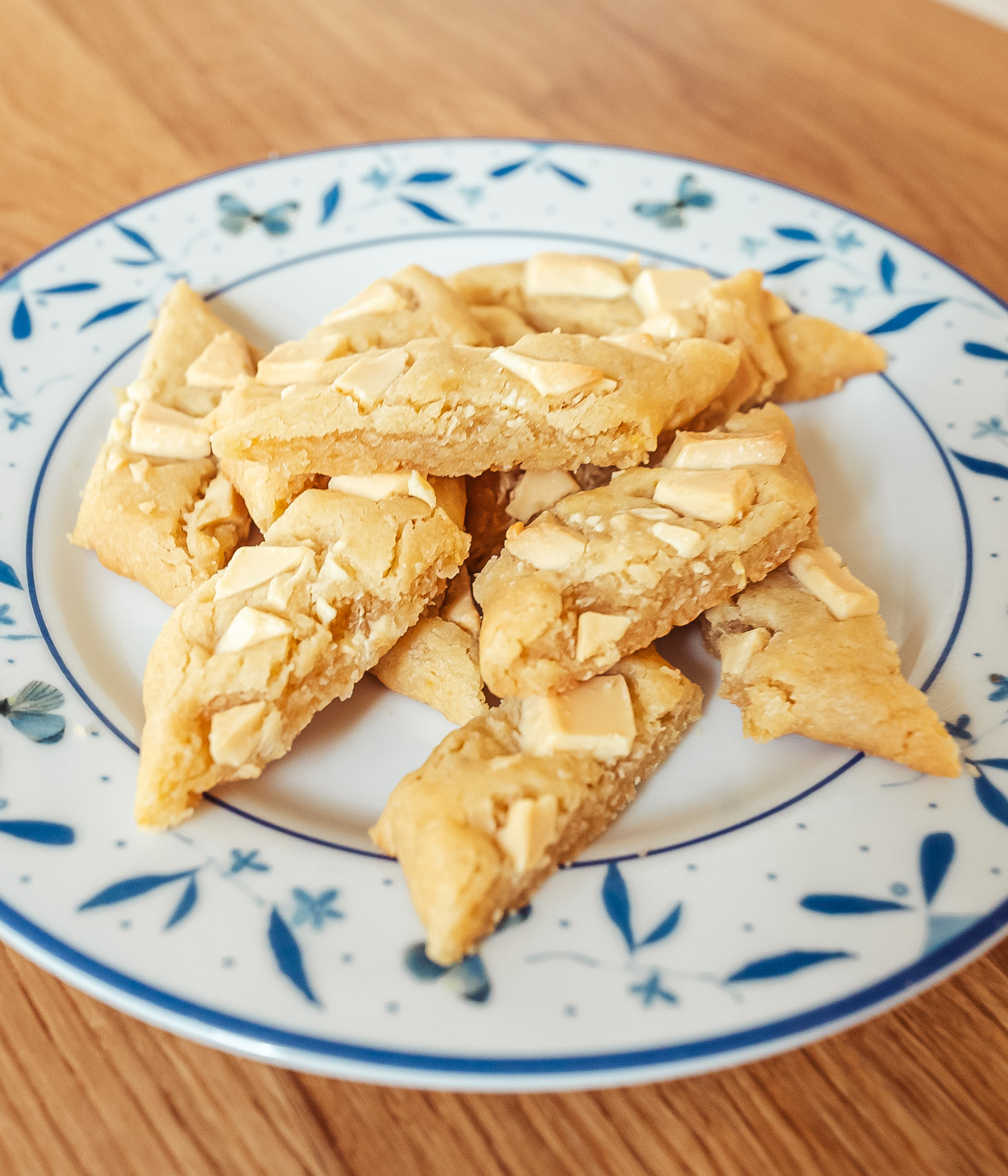 Swedish lemon and white chocolate slice cookies on a plate with blue butterflies