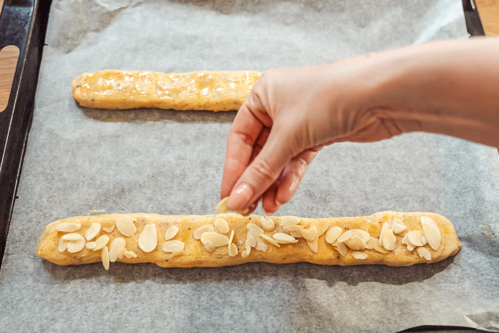 sprinkling almonds on cookie dough