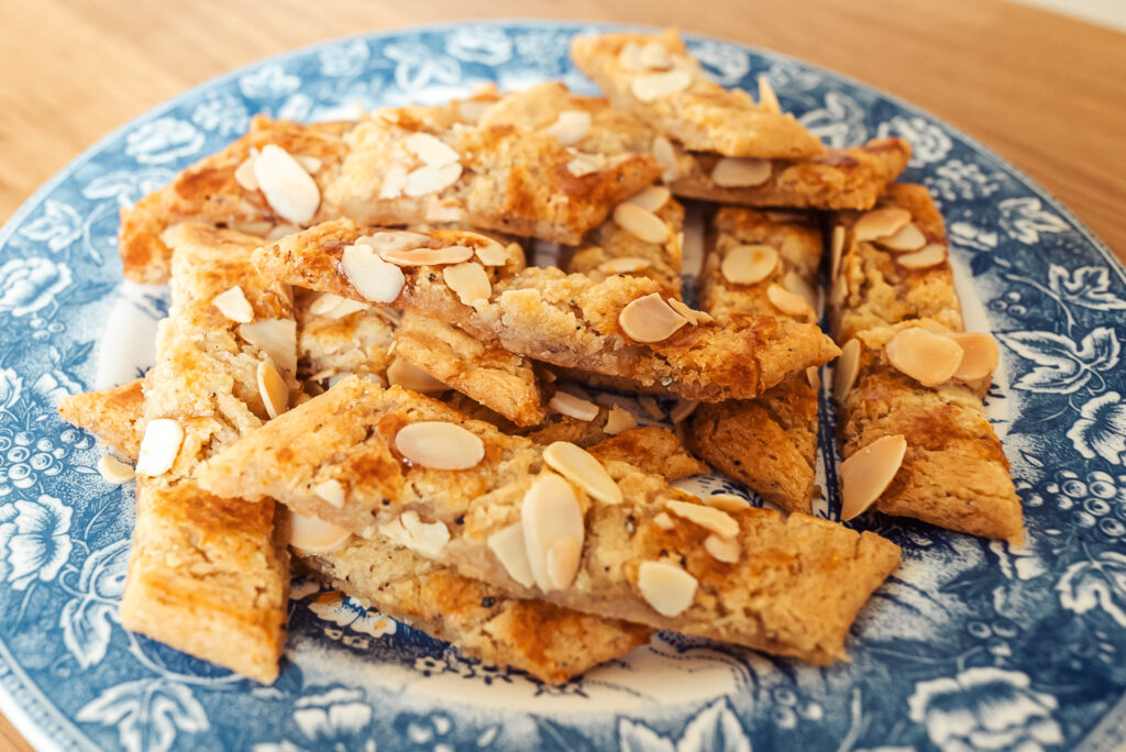 Scandinavian almond bars (sliced cookies) on a blue plate