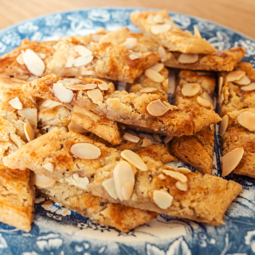 Scandinavian almond bars (sliced cookies) on a blue plate