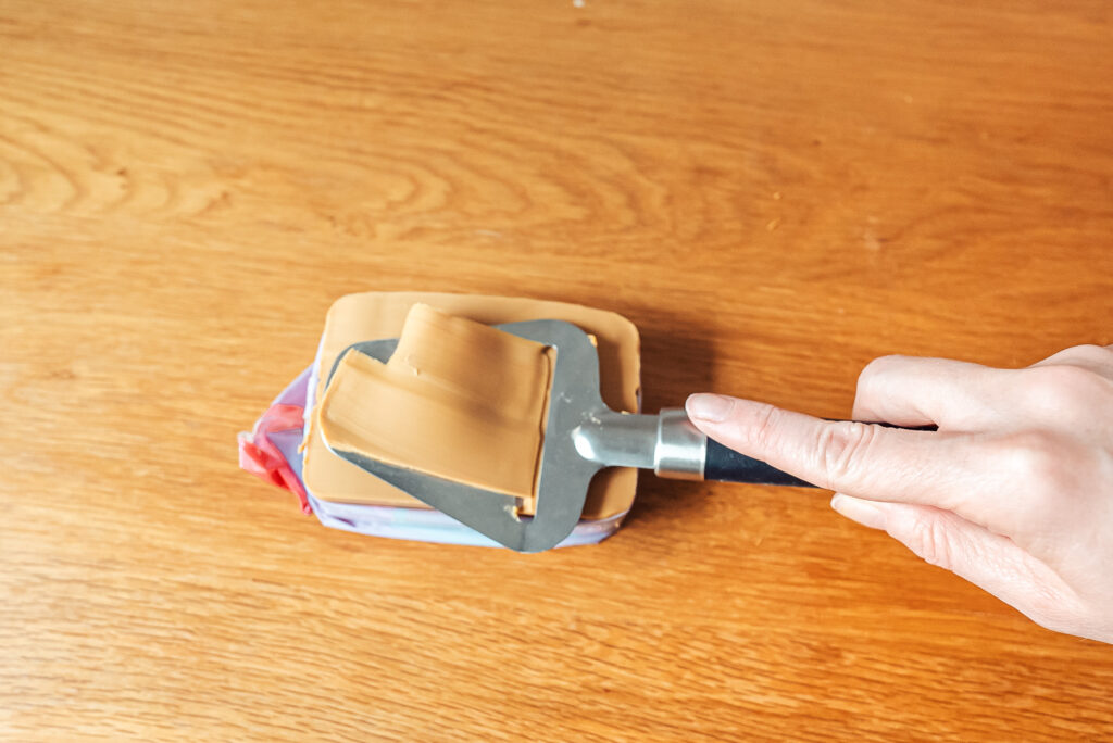 slicing brown cheese
