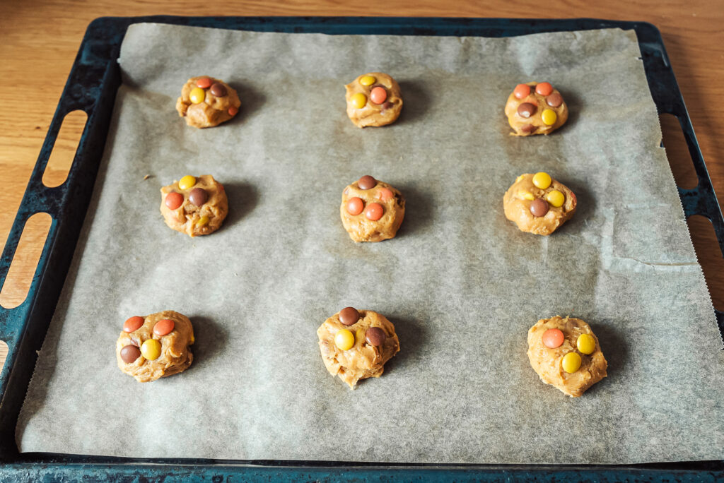 brown cheese cookies on a baking sheet