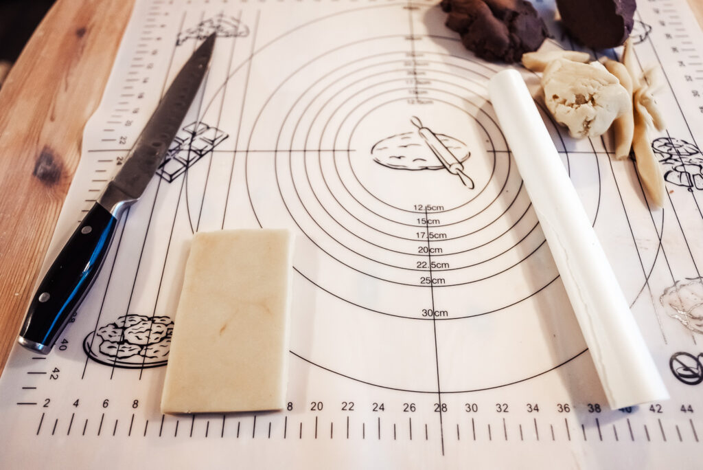 rolling out and measuring schackrutor checkerboard cookie dough
