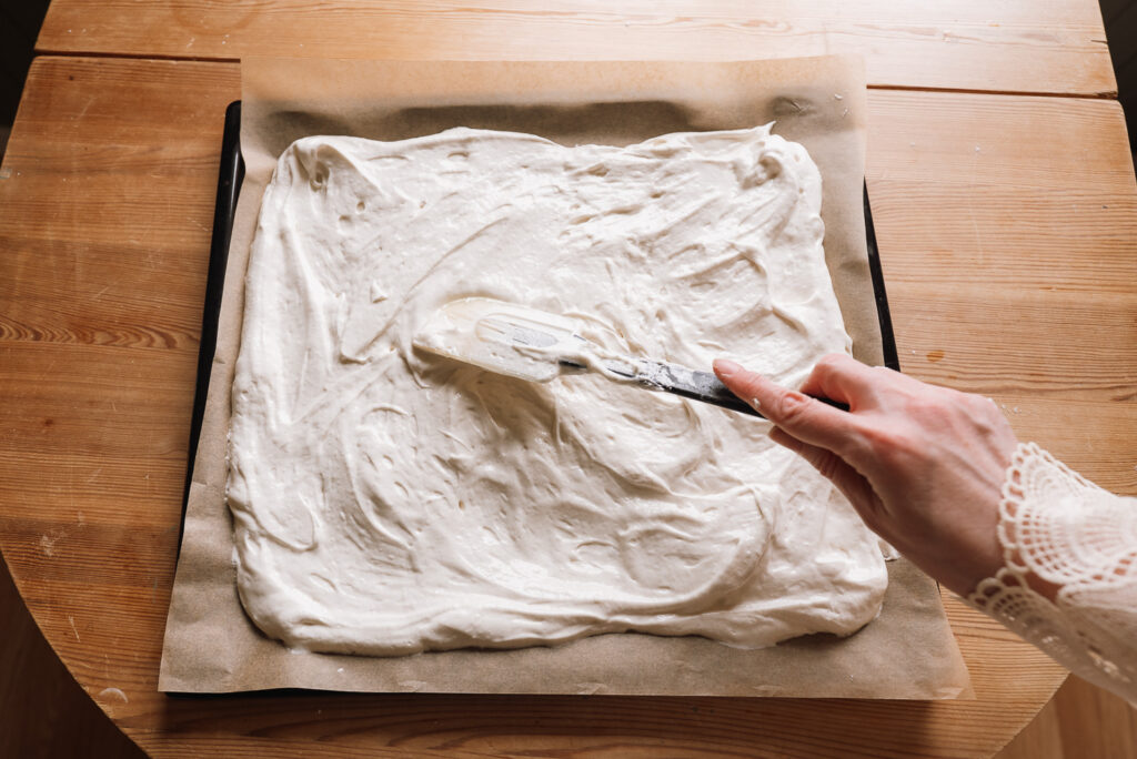 spreading budapest cake batter on baking paper